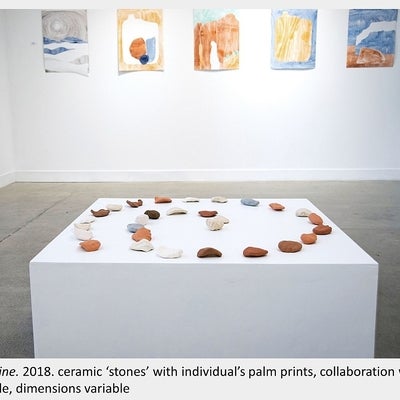 Artwork by Sara Pearson - Life Line. 2018. ceramic ‘stones’ with individual’s palm prints, collaboration with 29 people,