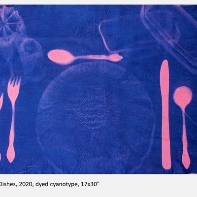 Negative photograph in blue and pink showing a table place setting