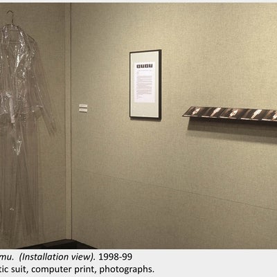 Artwork by Melissa Gordon. Adumu (Installation view). 1998-99. Plastic suit, computer print, photographs.