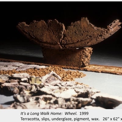 Artwork by Mary-Lynne Snedden. It's a Long Walk Home: Wheel. 1999. Terracotta, slips, underglaze, pigment, wax. 26“ x 62" x 14"