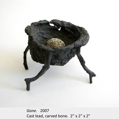 Artwork by Amy Switzer. Gone. 2007. Cast lead, carved bone. 2” x 2” x 2”