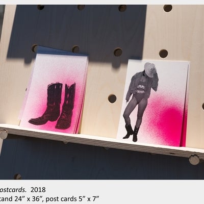 Artwork by Tait Wilman. Postcards, 2018, stand 24” x 36”, postcards 5” x 7”