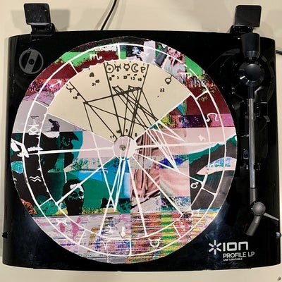 Artwork of a handmade playable record with astrology charts superimposed and engraved onto it.