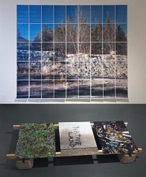 Gallery installation; on wall - landscape composed of pages in grid of 9 by 5, on floor 3 photos - centre one reads Native Land