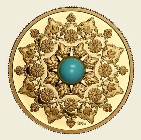Gold coin with a turquoise gemstone in the center encircled arabesque patterns and floral designs.