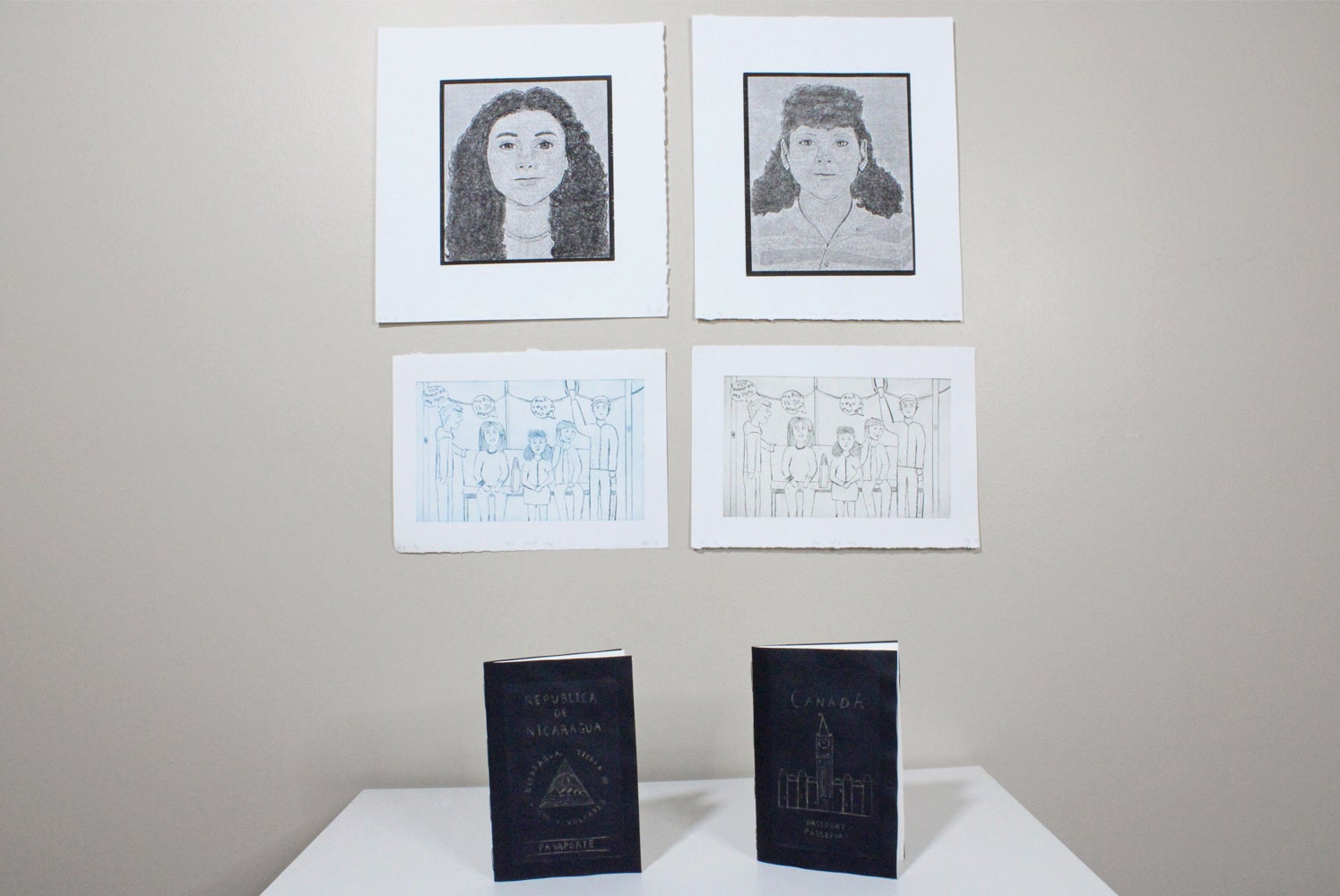 Installed artworks. Pinned on the wall are two portraits, underneath are matching line etching of five people at gathering, belo