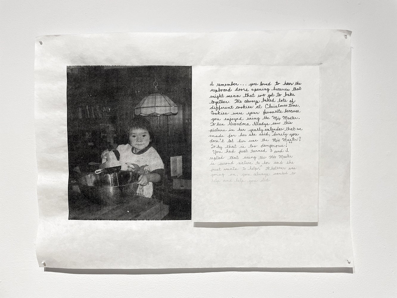 Artwork with a black and white photo of a chid using egg beaters and a handwritten note with ink fading from black to barely vis