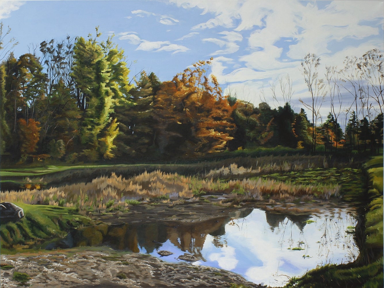 Painting of a landscape.  Trees, in autumn, at the edge of a small pond with cloudy reflected in the water.