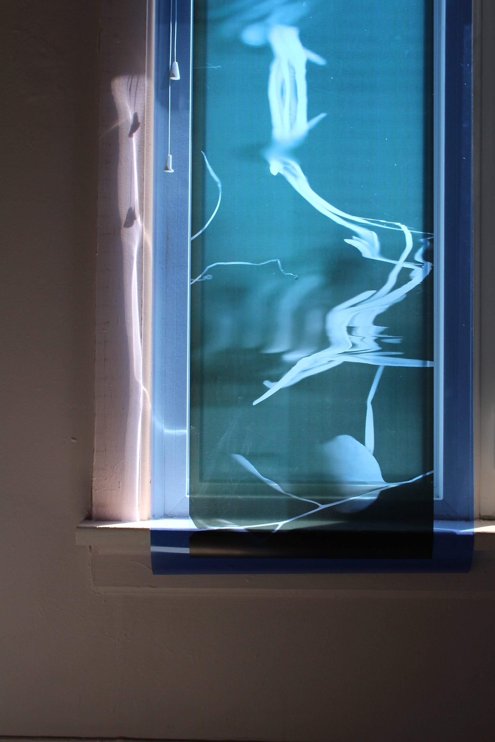 Window cover with transparent blue film.