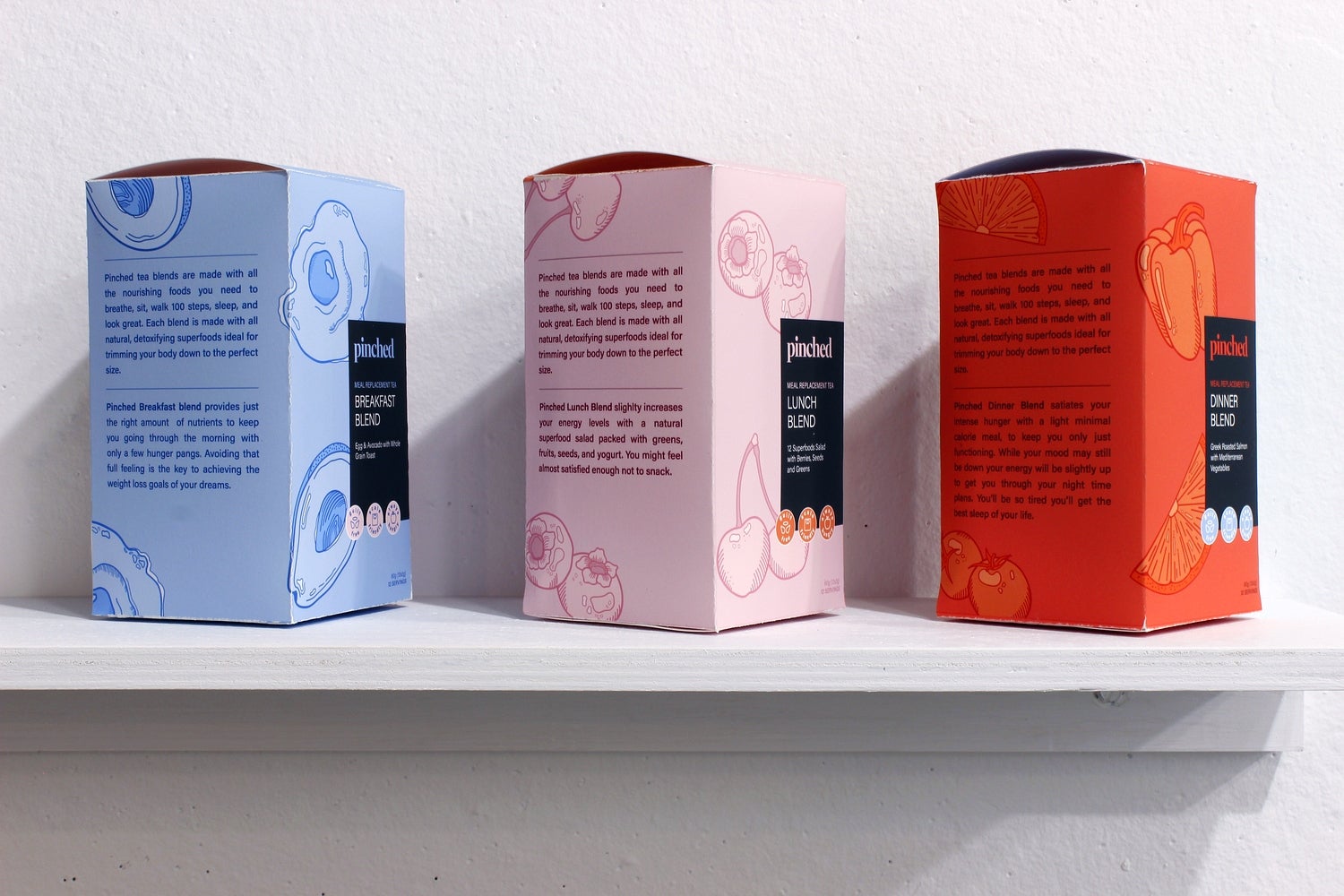 Art installation of shelf with 3 boxes of fake meal replacement tea with side labels describing teas