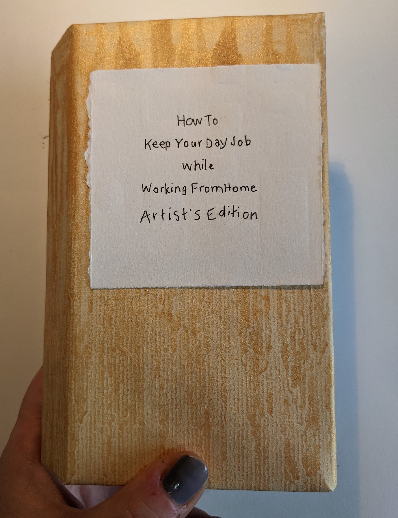 Accordion style book closed, cover text "How to keep your day job while working from home, Artist's Edition