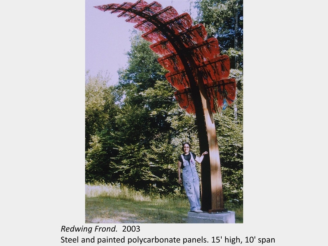 Artwork by Darlene Bolahood. Redwing Frond. 2003. Steel and painted polycarbonate panels. 15' high, 10' span