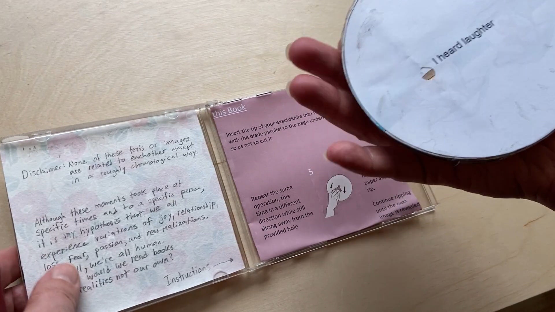 Artwork, open CD case with text and circular work reading "I heard laughter" 