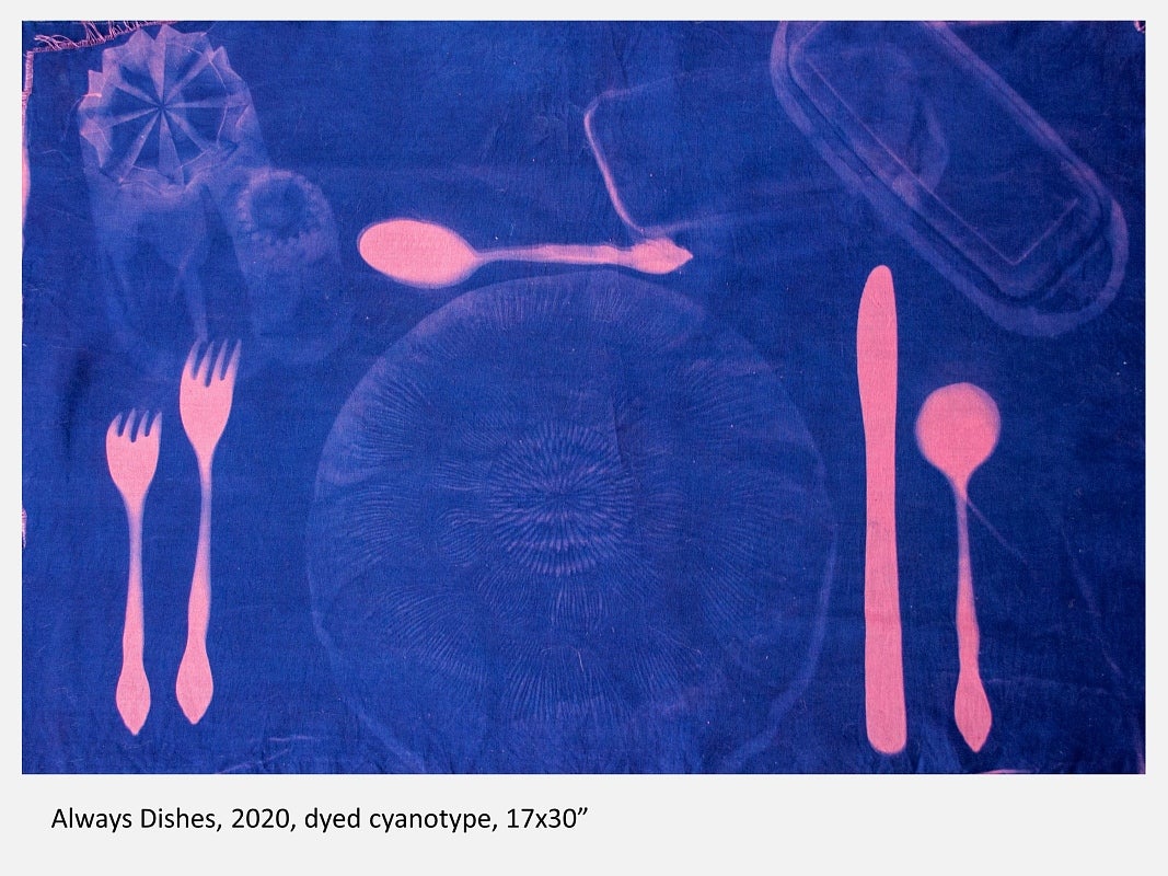 Negative photograph in blue and pink showing a table place setting
