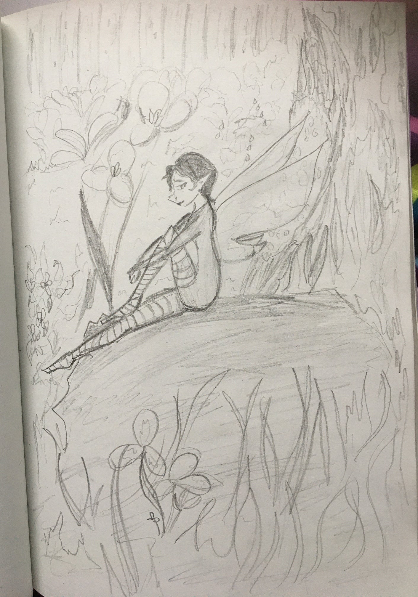 Drawing of a winged fairy sitting in a flower garden.