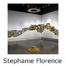 Gallery with collaged photographs in the row across two walls and text "Stephanie Florence"