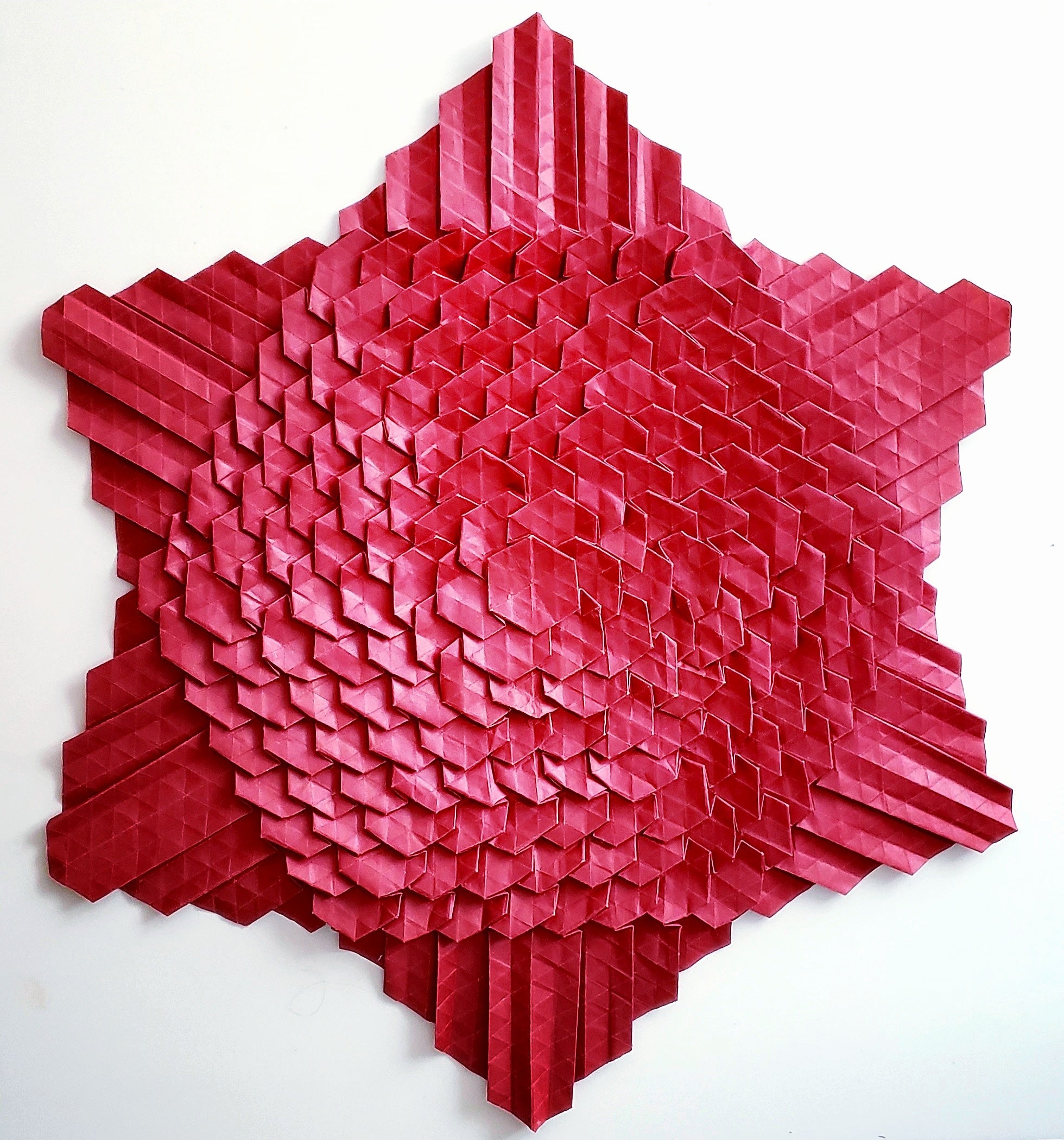 Red six pointed star with textured surface.