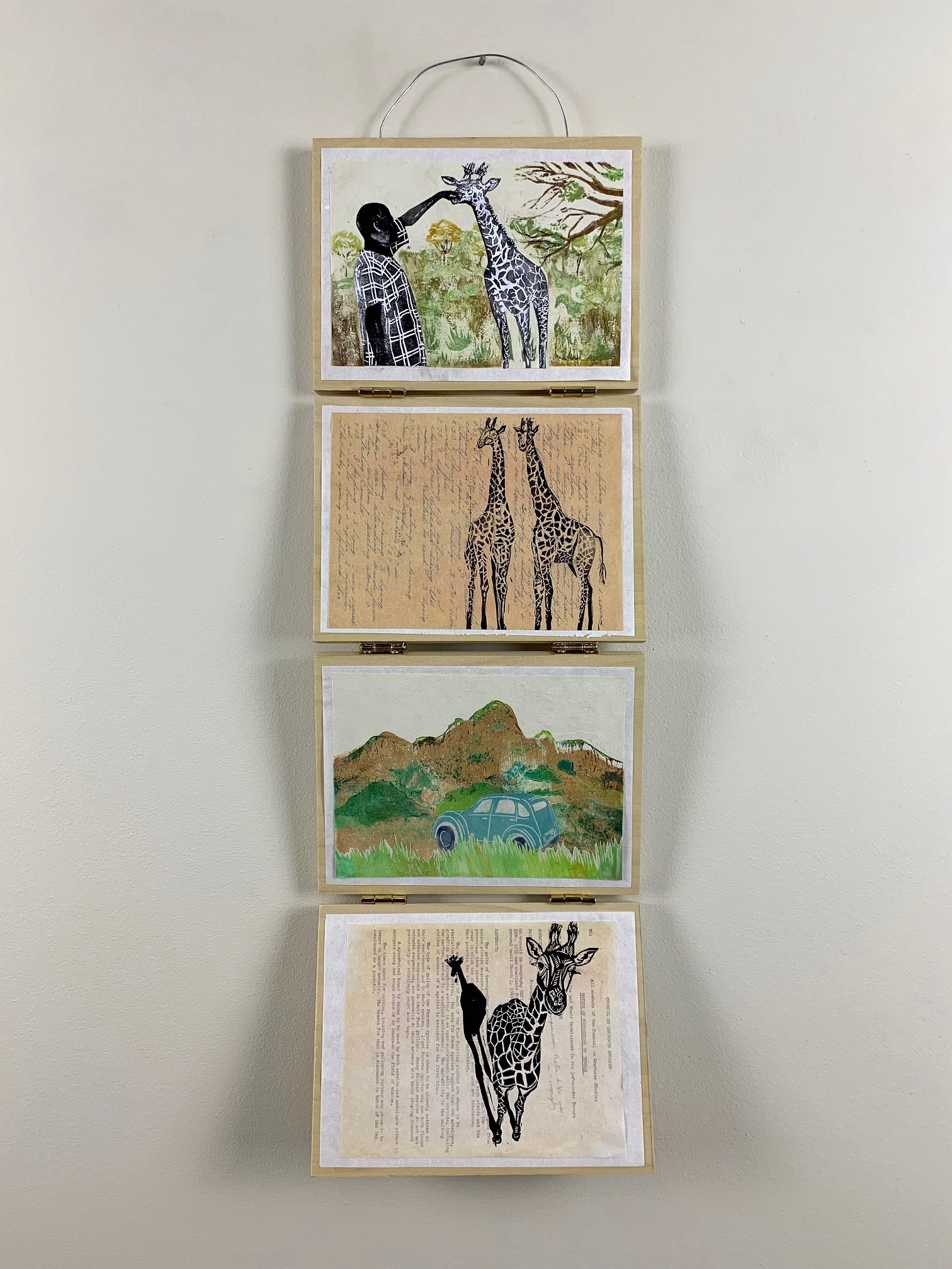 Series of four artworks hanging vertically on hinged panels. Works show a figure with a giraffe, two giraffes, text, landscape 