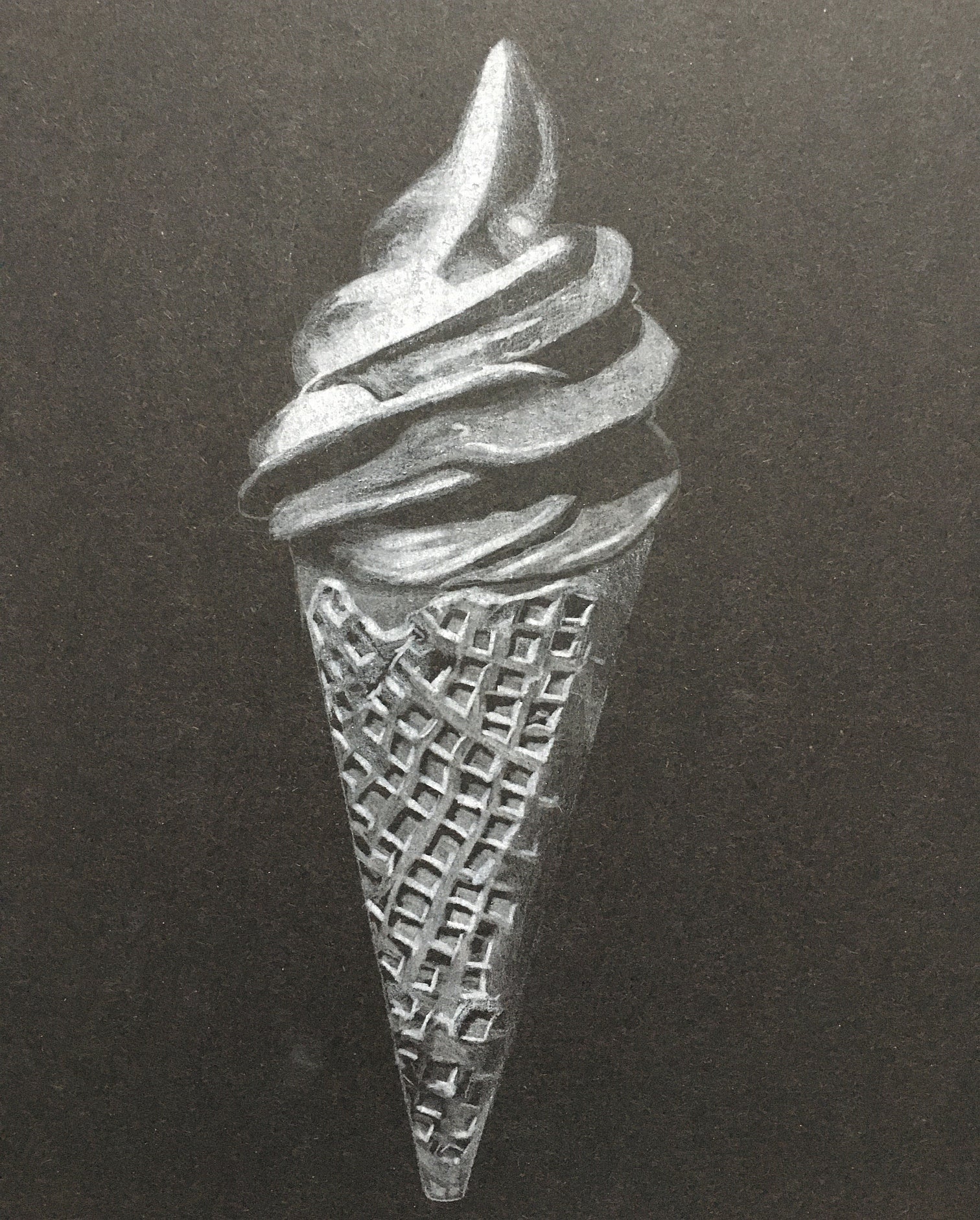 Black and white soft-serve style ice cream in waffle cone, on black background