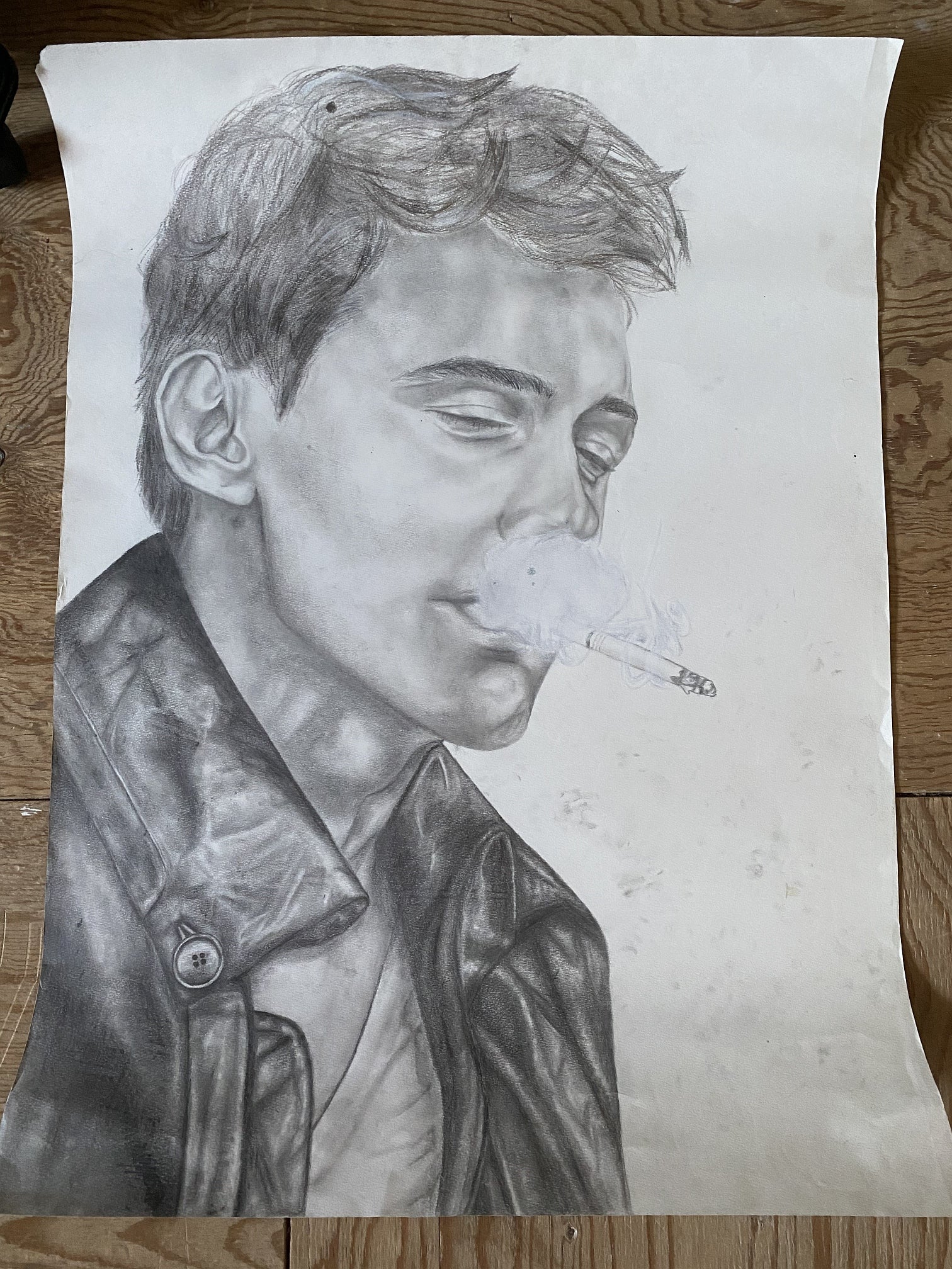 Portrait drawing, 3/4 view of person in leather jacket looking down with cigarette in their mouth, smoke blocks view of  mouth