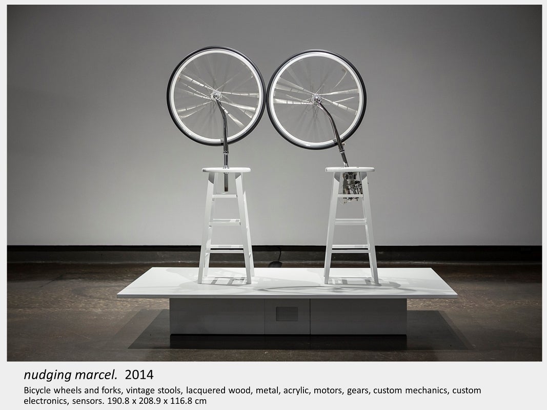 Artwork by Lois Andison.  nudging marcel.  2014, Bicycle wheels and forks, vintage stools, lacquered wood, metal, acrylic, motor