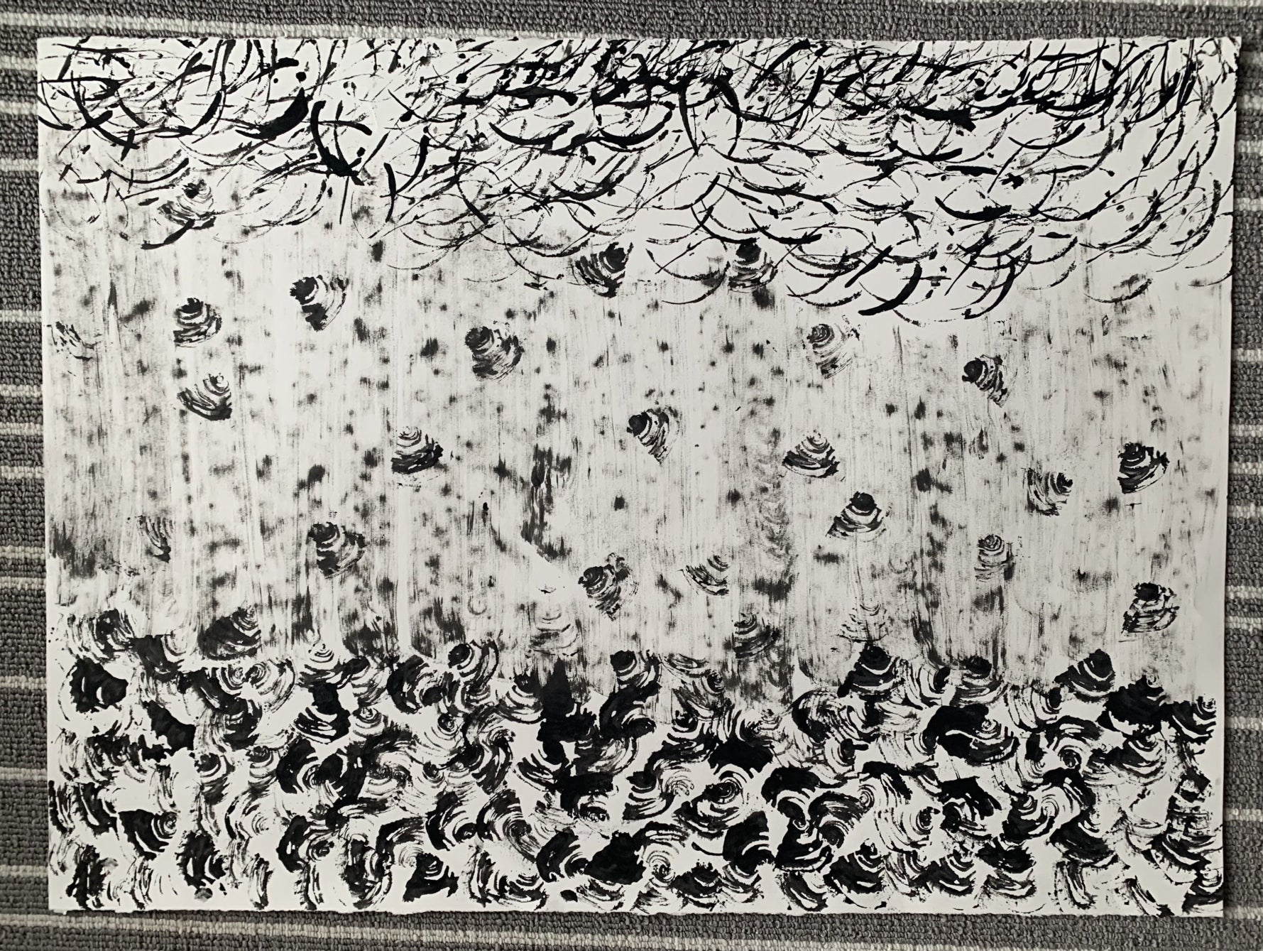 Abstract design in black and white; small curving lines at top, middle with vertical streaked topped with random triangular form