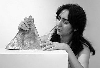 Portrait of Behnaz Fatemi holding a pyramid sculpture