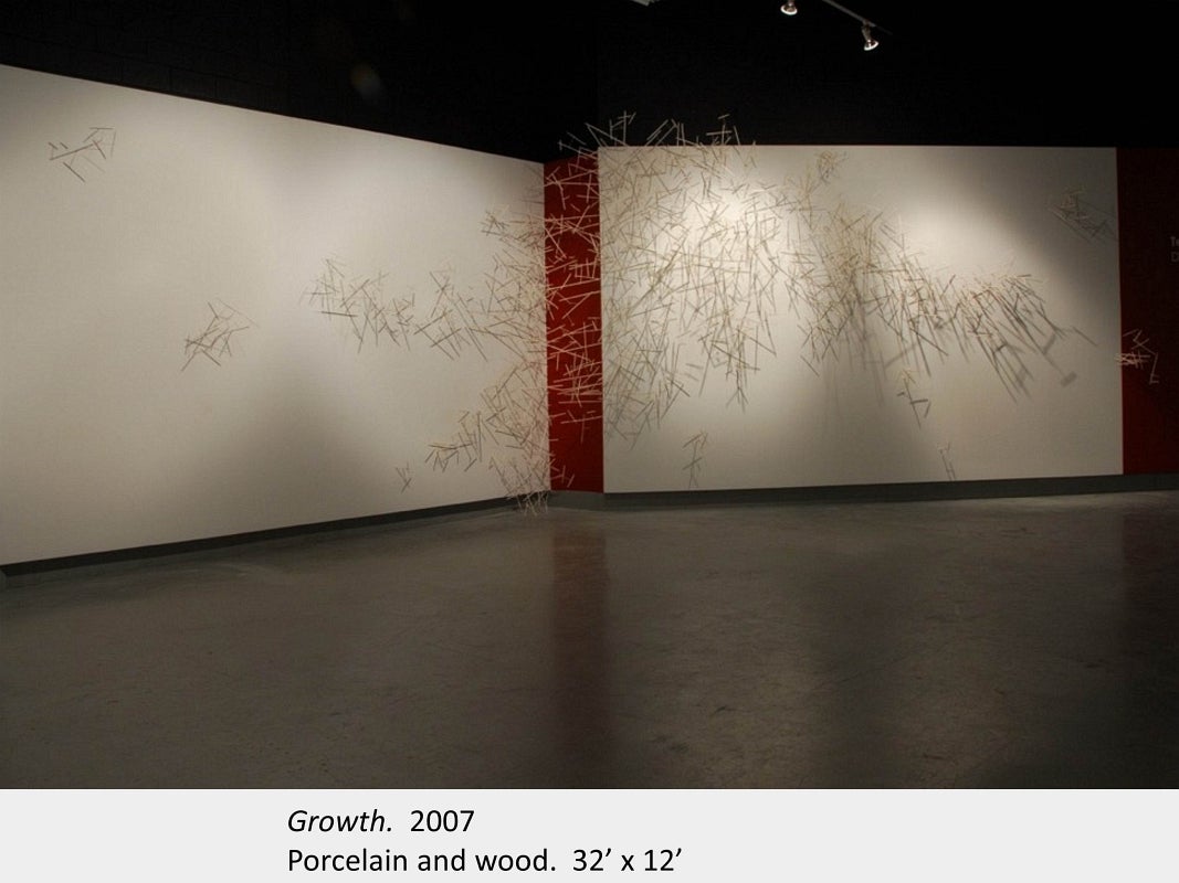 Artwork by Dawn Stafrace. Growth. 2007. Porcelain and wood. 32’ x 12’ 