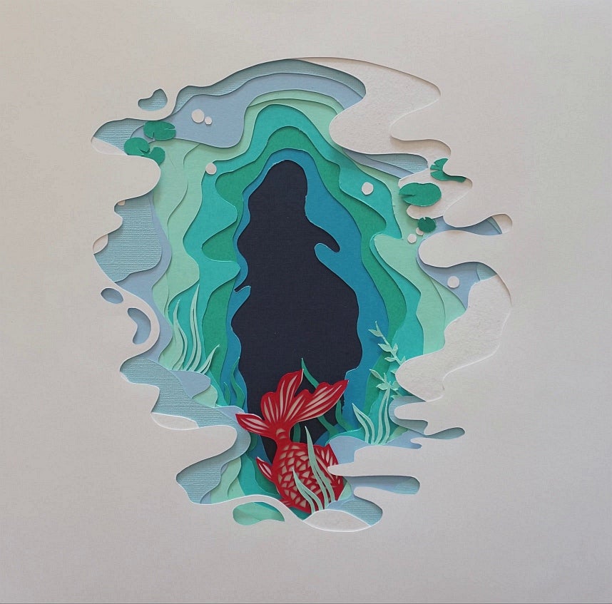 Paper cut-out artwork, white paper cut to reveal pages in shades of blue and green, orange carp "swims" underneath top paper.