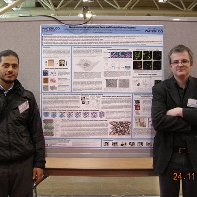 Torin Huzil and Mahmoud Elsabahy standing infront of poster.