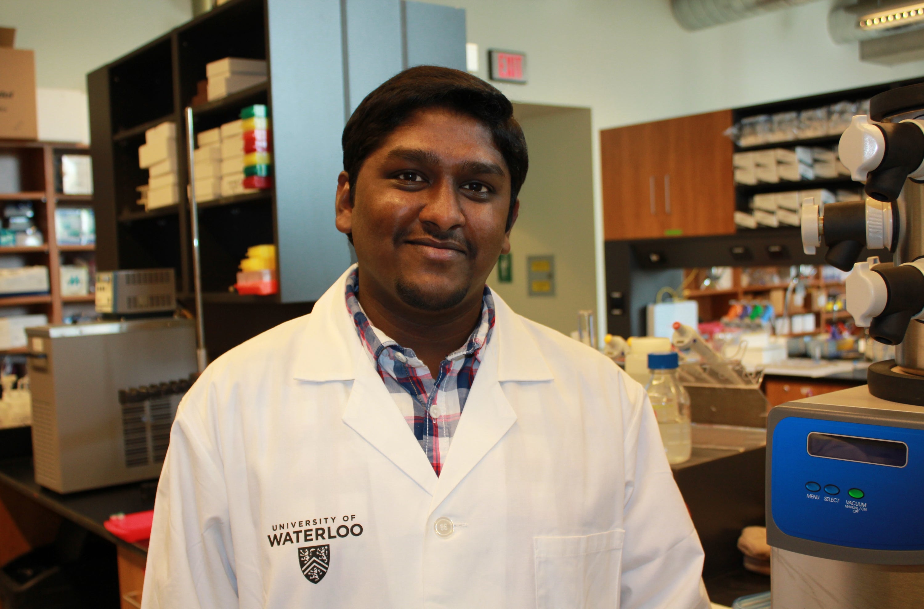 Lokesh Narsineni wearing lab coat in lab