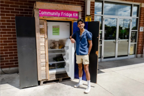 Kamil Ahmed, founder, standing in front of the KW Community Fridge