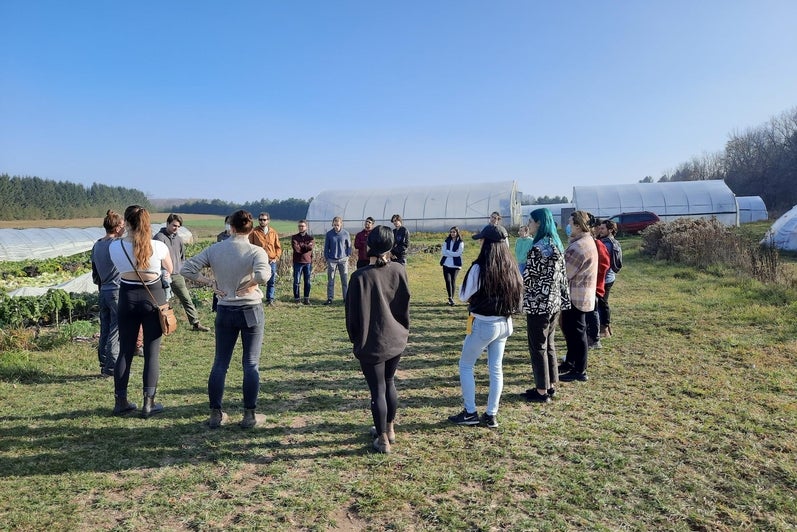 Class of GEOG 460 forming a sharing circle at Fertile Ground Farm