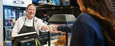 Student taking food from staff
