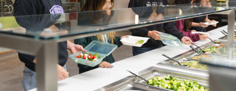 Students filling their plates with food at the dining hall