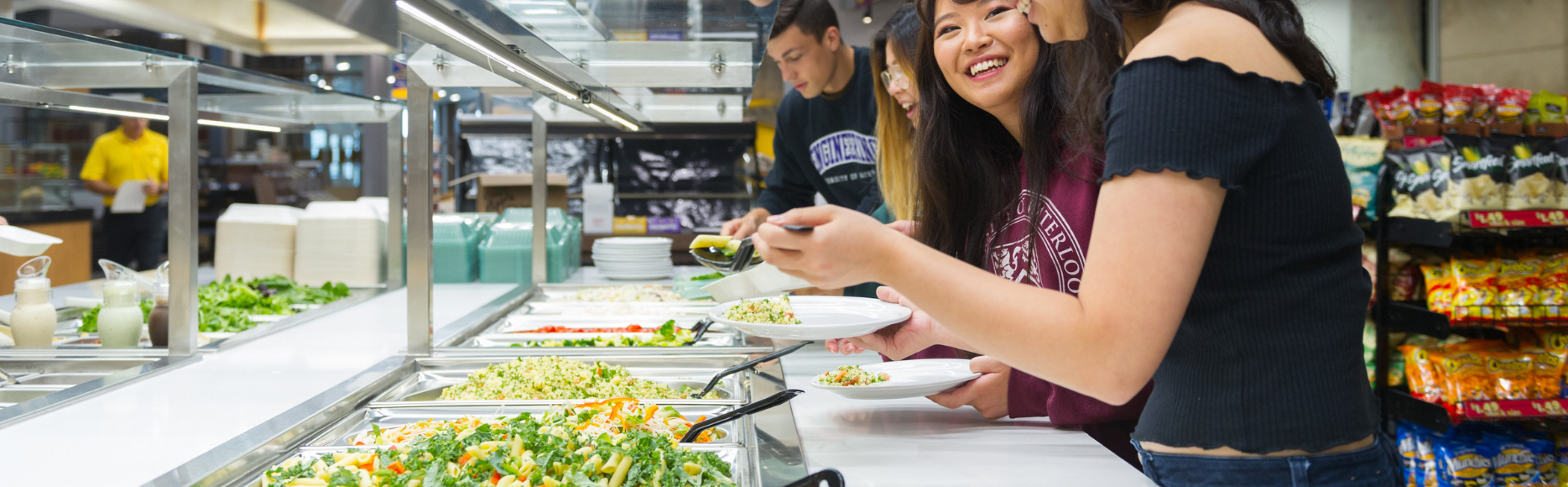 students grabbing food from the salad bar
