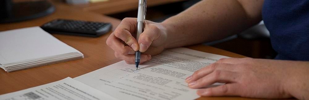 Image of person filling out a form