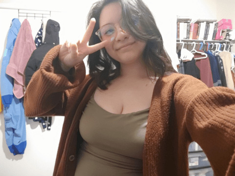 Malia Rosales-Grant with peace sign hand