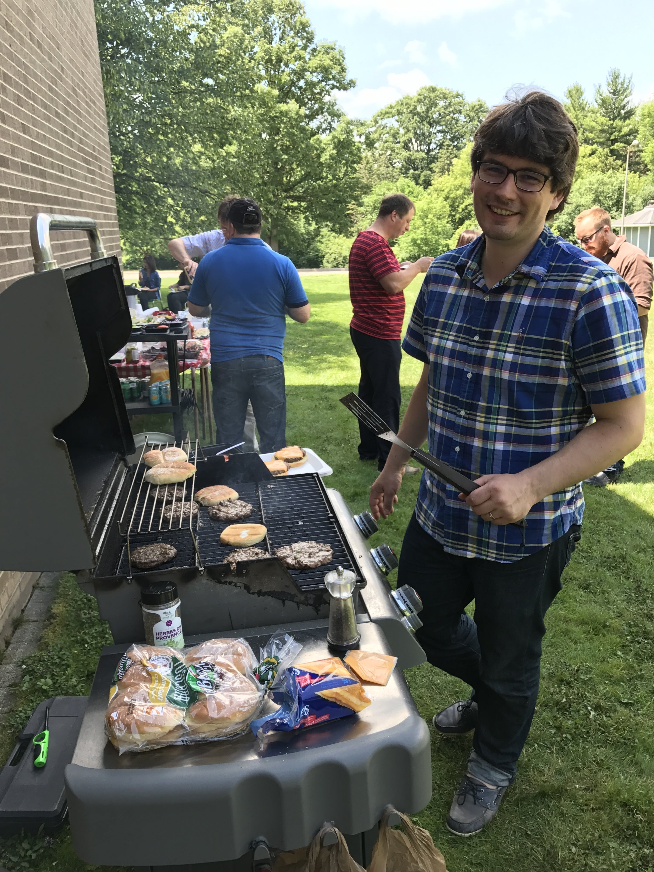 Professor Hebbinckuys grilling burgers at the department picnic.