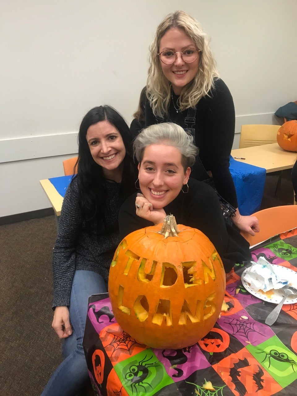 Grad students in French Studies carving pumpkins
