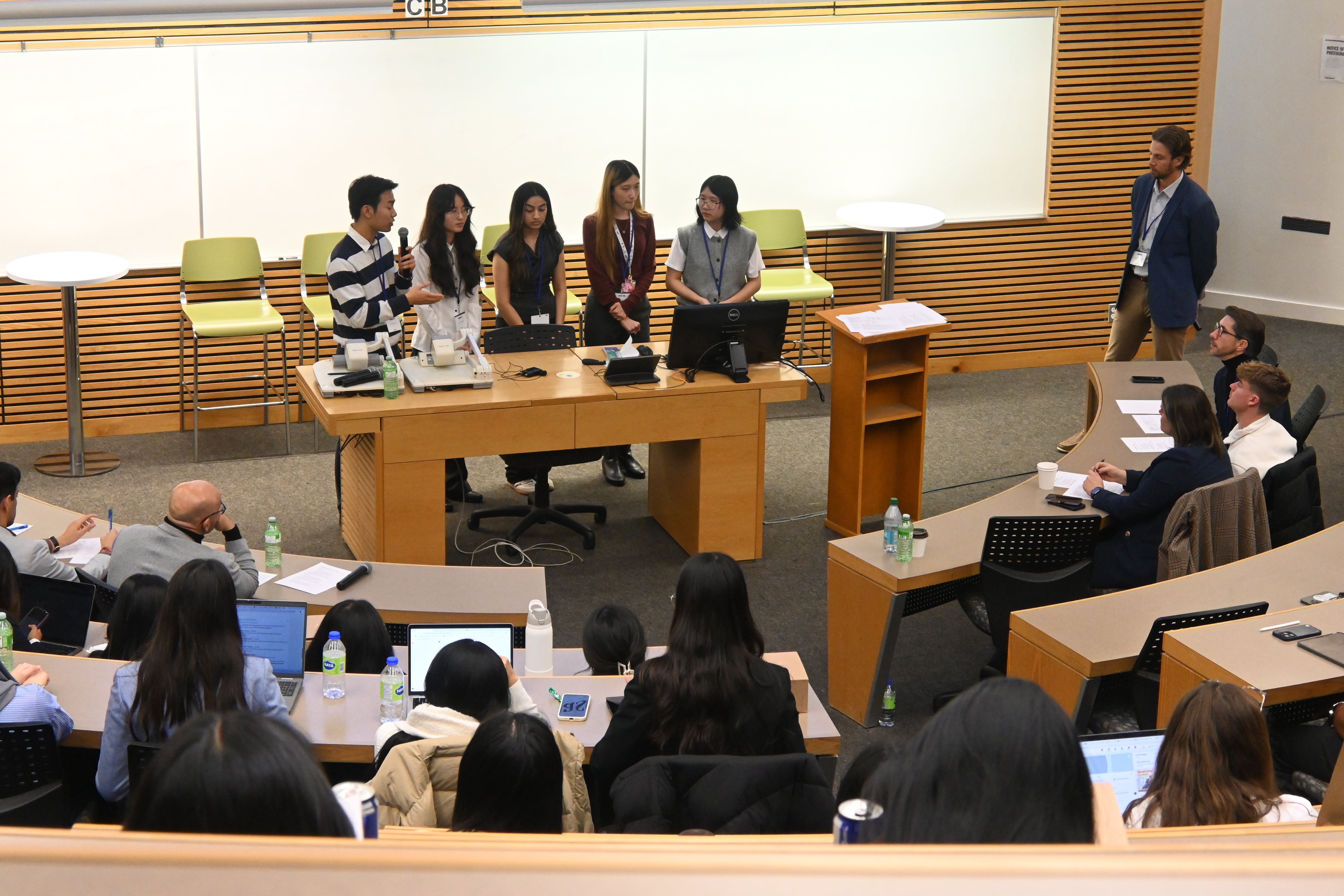 Far shot of group of students presenting