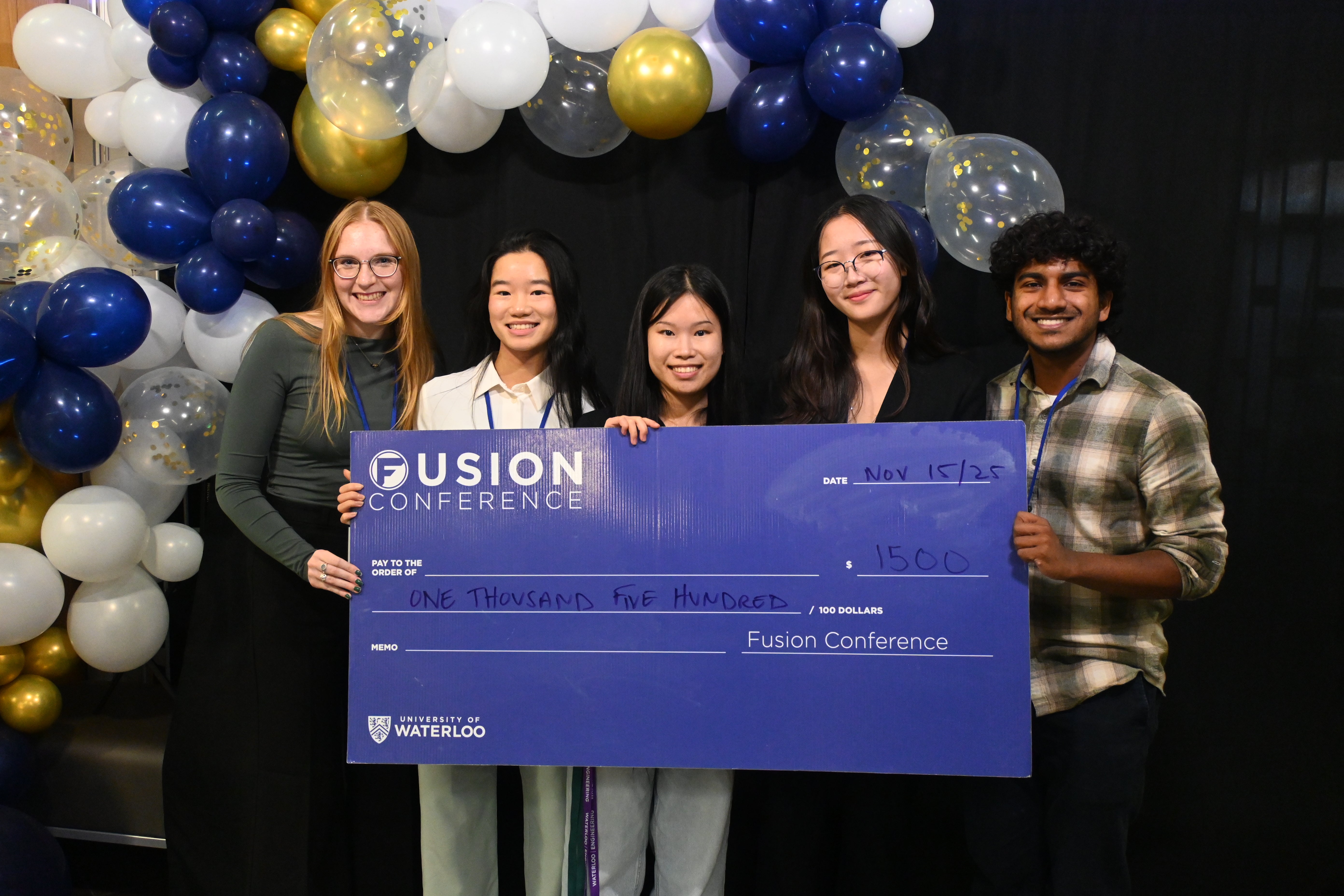 student posing with giant cheque
