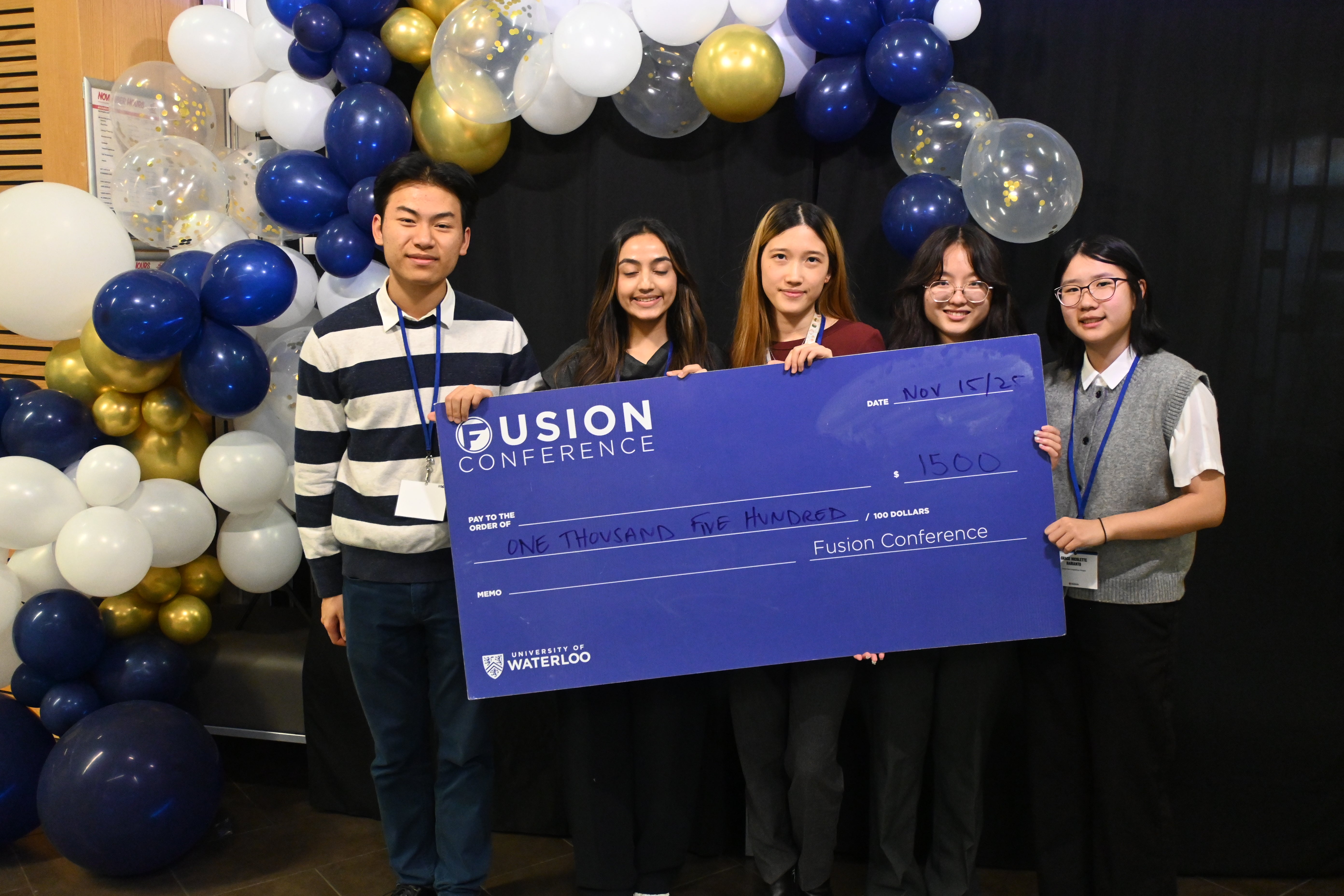 student posing with giant cheque