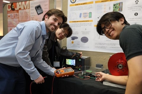 i-Capstone students test their project with a multimeter