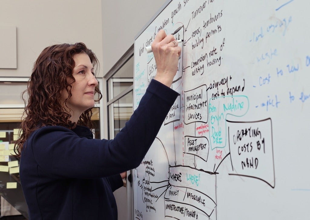 FCI Director Leia Minaker before a whiteboard 