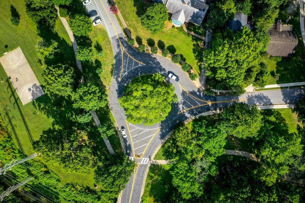 A green roundabout in a city.