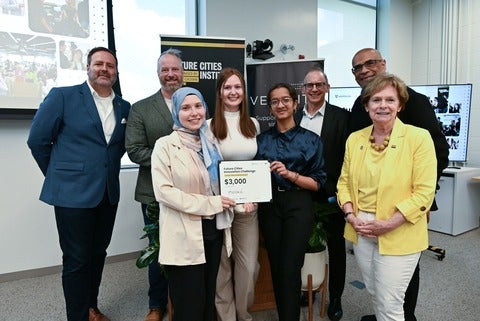 The winners and judges of the Challenge hold their winning plaque