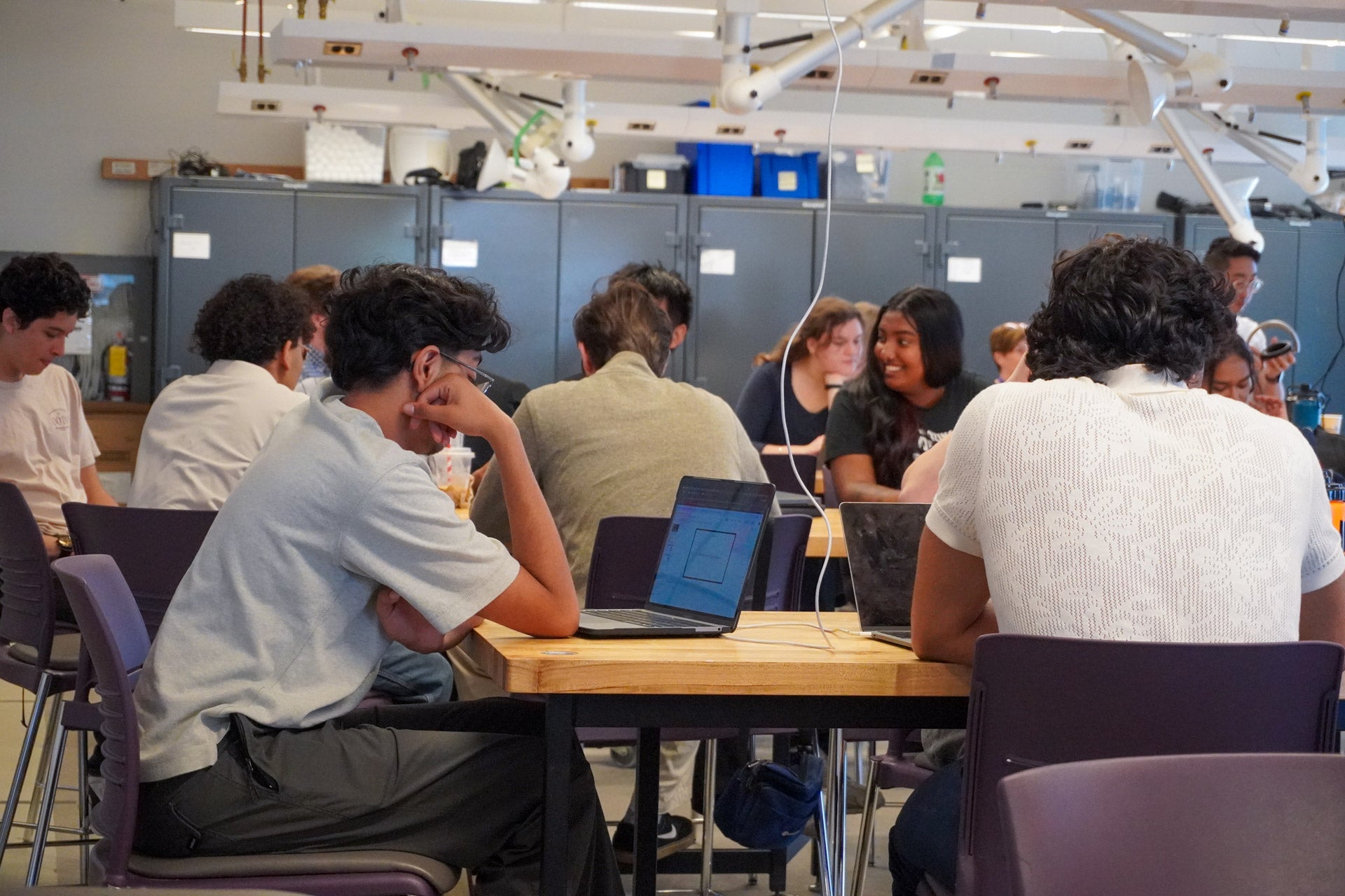 Students chat between presentations