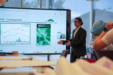 A student presents their project to the audience