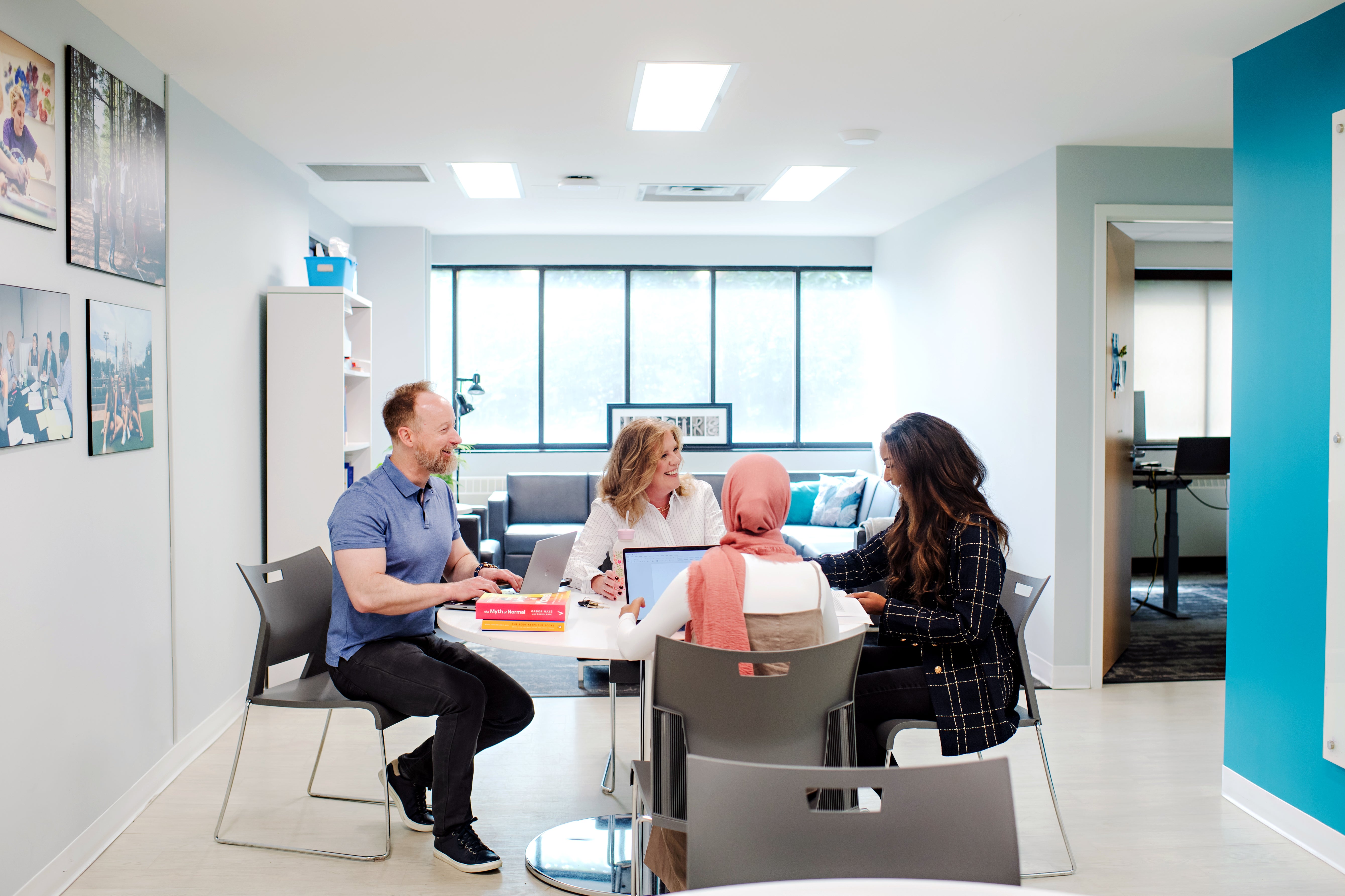 Researcher Dr.Diana C. Parry sites at a table with three other researchers.